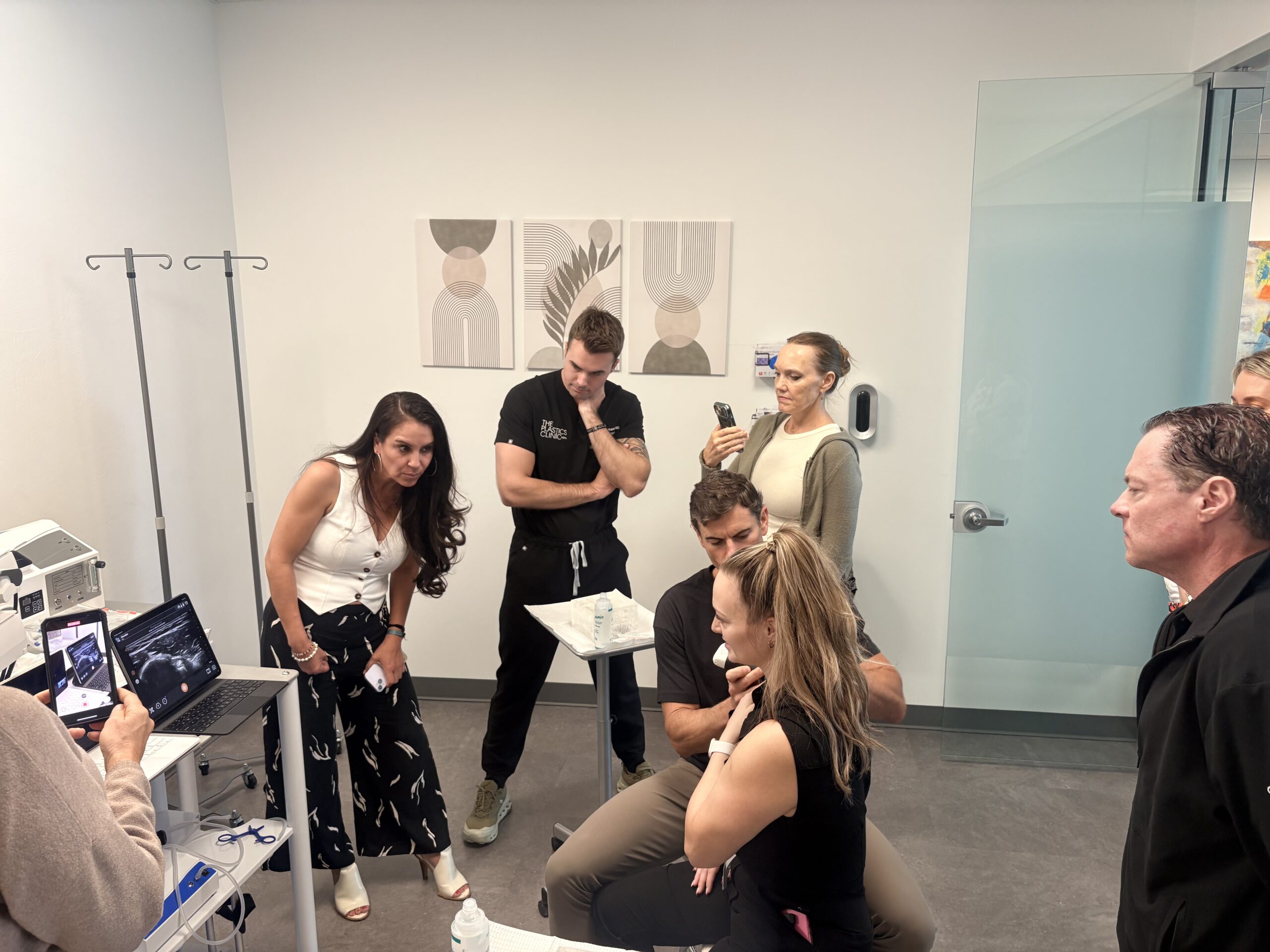 Participants observing a live ultrasound-guided procedure demonstration